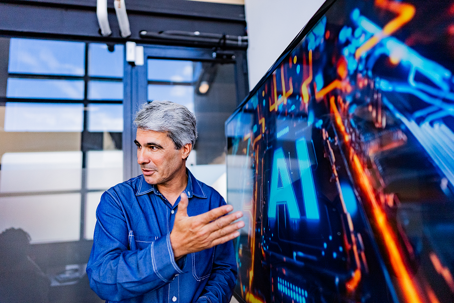 Man presenting AI technology on screen.